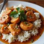 Final presentation of Cheesecake Factory orange chicken meal with stunning garnishes, perfect for a delicious dinner.