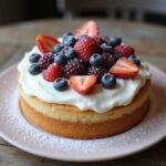 Gorgeous final result of French vanilla cake mix recipe, decorated with frosting and berries.