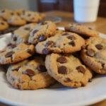 Deliciously baked peanut butter oatmeal chocolate chip cookies displayed on a plate, showcasing their gooey texture and warm chocolate chips.