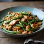 Final presentation of chicken and green bean stir fry, capturing its appeal as a quick, healthy meal option, rich in color and flavor.