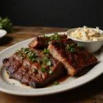 Deliciously plated smoked beef and ribs with fresh herbs, showcasing the perfect barbecue feast.