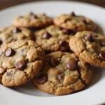 Delicious vegan oatmeal chocolate chip cookies on a plate, warm and inviting.
