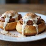 Deliciously baked sourdough cinnamon rolls drizzled with icing, showcasing the perfect recipe for an indulgent breakfast treat.