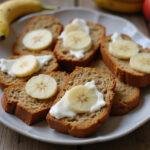 Variety of banana bread slices on display, featuring banana apple bread and pineapple banana bread, perfect for dessert lovers.