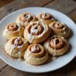 Enjoying delicious cake mix cinnamon rolls served on a plate, representing the ultimate indulgence in cake mix desserts with a charming presentation.