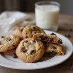 Delicious chickpea chocolate chip cookies served on a plate with melted chocolate chips, perfect for a healthy treat.