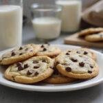 Deliciously warm classic homemade chocolate chip cookies on a plate, embodying grandma's chocolate chip cookies, perfect with a glass of milk.
