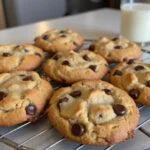 Deliciously baked copycat Crumbl cookies on a cooling rack, served with a glass of milk, perfect for any occasion.