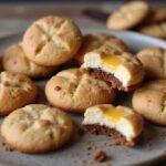 An enticing display of various cheesecake cookie recipes including flavors and stuffings, showcasing chocolate chip cheesecake cookies, ideal for home bakers.