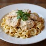 Final presentation of marry me chicken pasta, showcasing creamy sauce coated chicken and pasta, perfect for a romantic dinner.