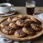 Final presentation of delicious Dove crumbl cookies on a rustic plate with coffee, showcasing the irresistible treat.