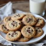 Delicious no bake chocolate chip cookies displayed on a plate with a glass of milk ready to enjoy.