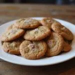 Freshly baked ginger molasses cookies displayed on a plate, highlighting the deliciousness of this ginger molasses cookie recipe with Mrs. Fields inspiration.