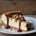 Final display of a high protein cheesecake slice, showcasing its rich texture and delicious toppings in a delightful setting.