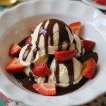 Delicious final result of homemade ice cream recipe with fresh strawberries and chocolate sauce, perfect for summer treat.