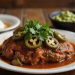 Delicious Mexican meatloaf displayed on a wooden table, featuring vibrant garnishes and accompaniments, perfect for a taco night.