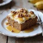 Delicious slice of no-bake banana bread dessert on a rustic wooden table, garnished with honey and walnuts for a mouthwatering presentation.