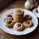 Coconut pecan cookie recipe presented on a plate, showcasing irresistible pecan cookies garnished with powdered sugar for a delightful finish.