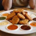 Deliciously reheated chicken nuggets served with sauces for an appetizing meal.