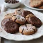 A stunning presentation of rich chocolate wafer cookies, chocolate fudge cookies, and chocolate drop cookies arranged on a plate, showcasing a mouthwatering chocolate cookie recipe.