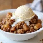 Delicious air fryer apple crisp with a scoop of vanilla ice cream, perfect dessert presentation for an easy and warm treat.