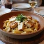 A stunning presentation of baked feta pasta with chicken, showcasing a deliciously creamy and cheesy dish, perfect for serving at dinner.