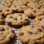 Delicious brown butter oatmeal chocolate chip cookies cooling on a rack, showcasing their golden brown color and melted chocolate chips.