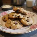 Delicious cream cheese chocolate chip cookies stacked on a plate, perfect for dessert or snack, with an inviting kitchen atmosphere.