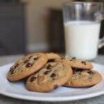 Deliciously baked high altitude chocolate chip cookies displayed on a plate, perfect pairing with a glass of milk for ultimate enjoyment.