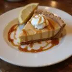 The stunning final result of Hogsmeade-Style Butterbeer Pie with Frothy Butterscotch Top, ready to be enjoyed in a delightful presentation.