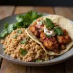 Final presentation of jerk chicken tacos and rice bowl, showcasing vibrant colors and appetizing flavors.