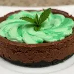 Final presentation of the Mystic Mint Chocolate Cheesecake with Slytherin Green Swirl, an indulgent dessert highlighting luxurious flavors and stunning visual appeal.