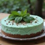 Finished Slytherin Mint Cheesecake with a rich chocolate cookie crust, decorated and ready to serve.
