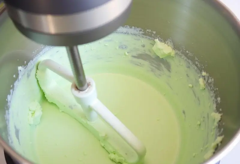 Blending cream cheese and mint extract for a delicious Slytherin Mint Cheesecake filling.