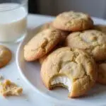 Deliciously baked sour cream and biscoff cookies on a plate, ideal for enjoying with milk in a cozy dessert moment.