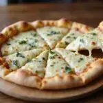 Delicious Great White Pizza with white garlic sauce, beautifully presented and ready to be enjoyed, showcasing cheese and crisp crust.