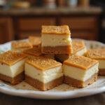 Final presentation of Golden Snitch Caramel Butterbeer Cheesecake Bars, beautifully plated to highlight their rich caramel topping and decadent cheesecake layers.
