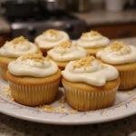 Final presentation of Golden Snitch Glazed Butterscotch Cupcakes with Butterbeer Frosting on a decorative plate, perfect for a magical dessert display.