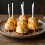 Finished Harry Potter Butterbeer Cheesecake Pops with luminous butterscotch drizzle, presented beautifully.