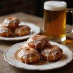 Plate of Hogwarts Hearth Baked Butterbeer Donuts, glazed and garnished, displayed with a warm mug of butterbeer, capturing the magical dessert experience.