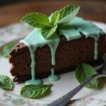 Final presentation of Slytherin Serpent Dark Chocolate Cheesecake with Mint Glaze, garnished for an elegant dessert display.