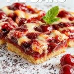A close-up of cherry pie bars arranged on a rustic wooden platter. The bars have a golden-brown crust topped with vibrant, glossy red cherry filling, sprinkled with powdered sugar. The edges are flaky and slightly crumbled, revealing layers of buttery crust and sweet cherry filling within.