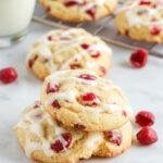 A plate of Festive Cranberry Orange Cookies showcasing vibrant red cranberries and orange zest on topped with powdered sugar, perfect for holiday celebrations.