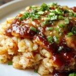 A plate of Honey BBQ Chicken served over fluffy rice, garnished with fresh herbs and a smoky glaze, perfect for a weeknight dinner.