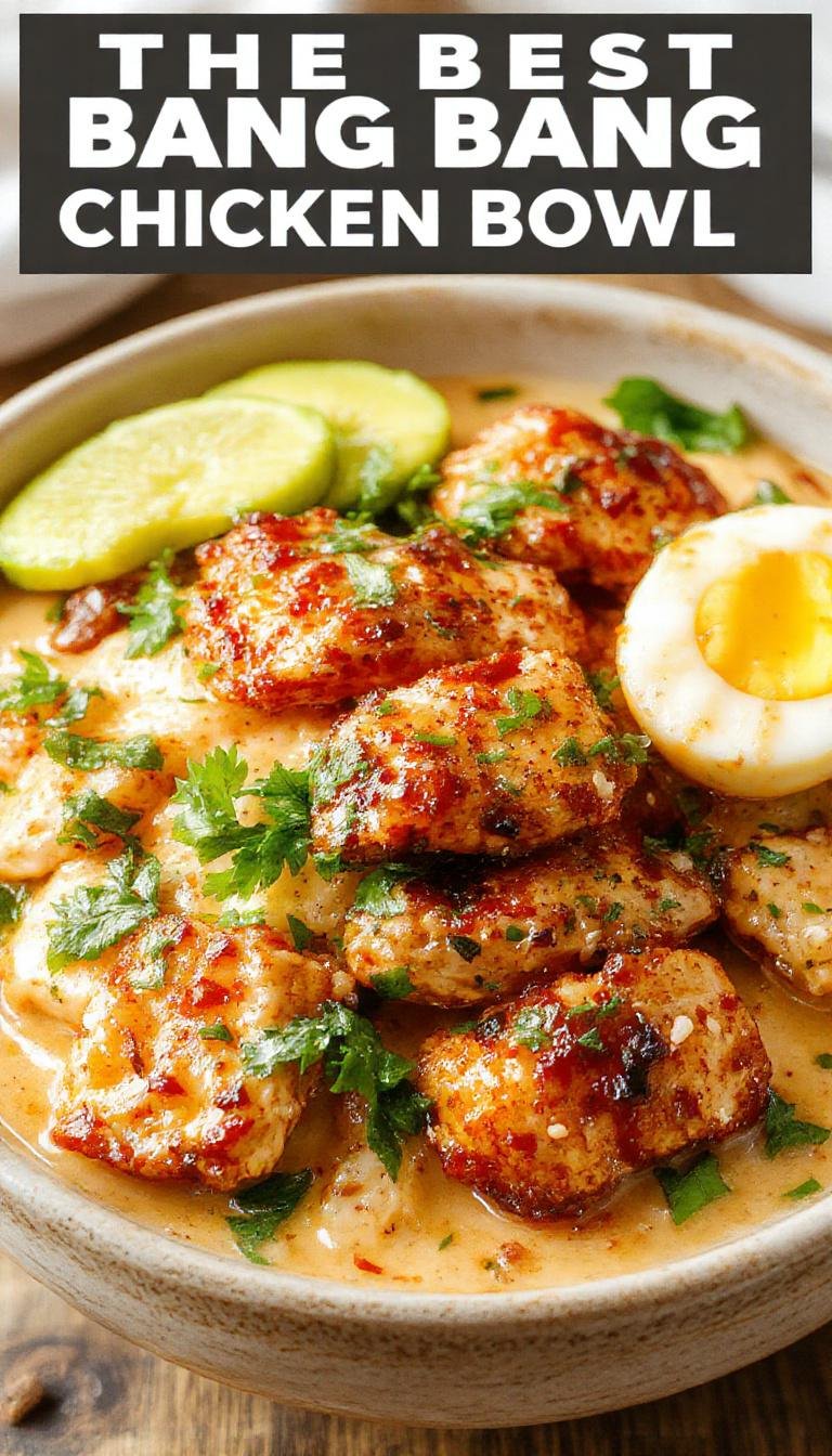 A vibrant bowl of Bang Bang Chicken with crispy chicken pieces coated in a creamy sauce, garnished with sliced green onions and sesame seeds.