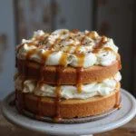 Stunning cake topped with buttercream icing and salted caramel, displaying a professional dessert creation.