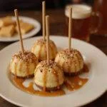 Delicious finished Hogwarts Spiced Butterbeer Cheesecake Pops displayed elegantly, perfect for a magical treat.