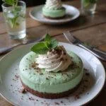 Final presentation of Slytherin Ambitious Mist Mint Cheesecake with whipped cream and chocolate shavings.